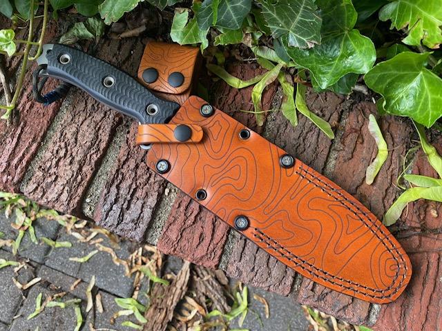 Custom, handmade leather sheath for Busse Hellrazor 2. Died in antique saddle tan with laser engraved topography.