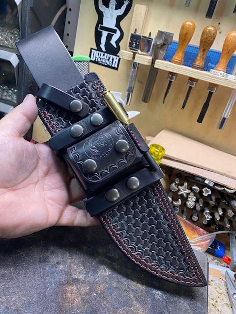Busse Trough Raider custom black leather sheath. Custom tooling with red stitching.