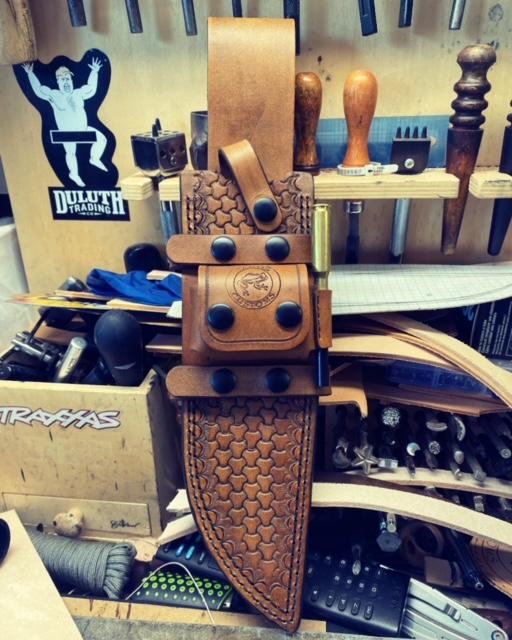 Busse Trough Raider custom, handmade tan sheath with black hardware.